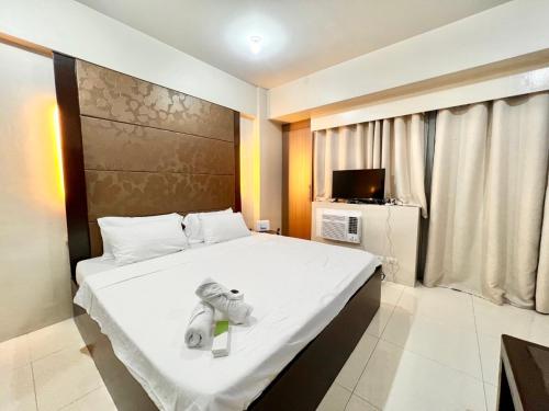 a bedroom with a large bed with towels on it at Newport Hotel near NAIA Manila Airport Terminal Pasay in Manila