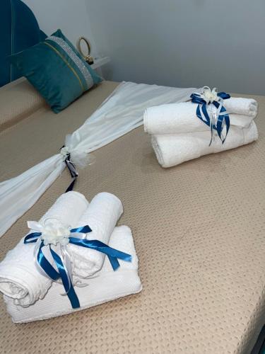 two folded towels are sitting on a bed at Alex mary home in Naples