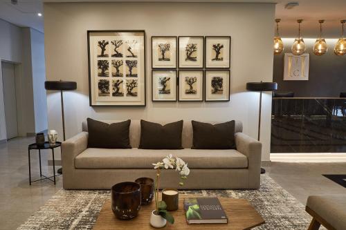a living room with a couch and pictures on the wall at The Catalyst Apartment Hotel by NEWMARK in Johannesburg