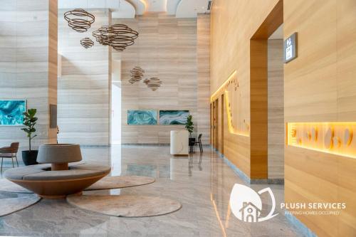 a lobby with a bench in the middle of a building at Sentral Suites by Plush in Kuala Lumpur