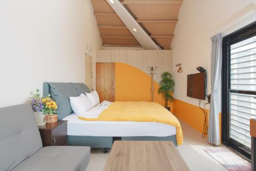 a bedroom with a bed with a yellow blanket at Arabian Nights in Jiufen in Jiufen