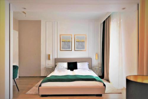 a bedroom with a bed with a green blanket on it at Studio no5 Green in Sighişoara