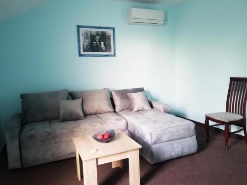 a living room with a couch and a table at Vila Dvor SUBOTICA in Subotica