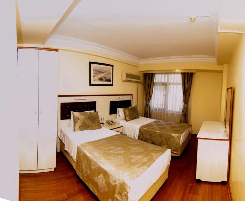 Кровать или кровати в номере Tayhan Hotel