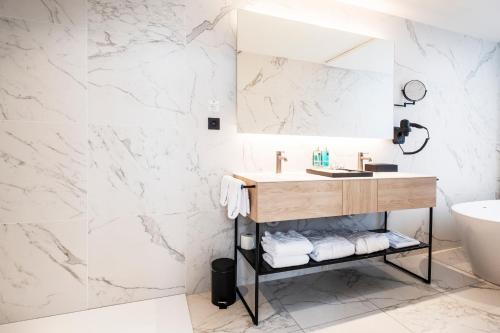 a bathroom with a sink and a mirror at Corsendonk Turnova in Turnhout