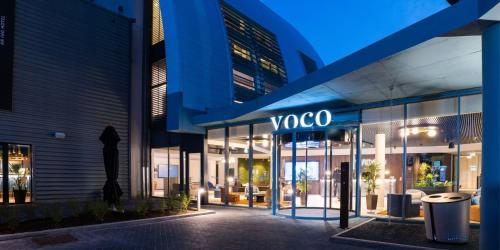 a building with a yoga sign on the side of it at voco Brussels City North by IHG in Vilvoorde