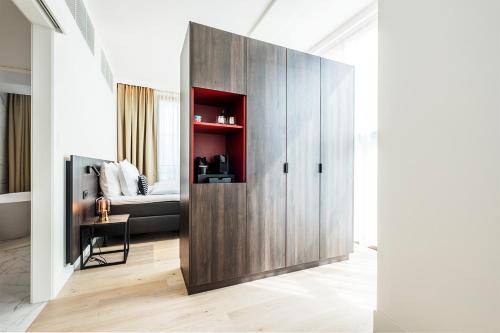 a large wooden door in a room with a bed at Corsendonk Turnova in Turnhout
