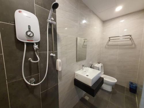 a bathroom with a shower and a toilet and a sink at Hotel Golden View Nilai in Nilai