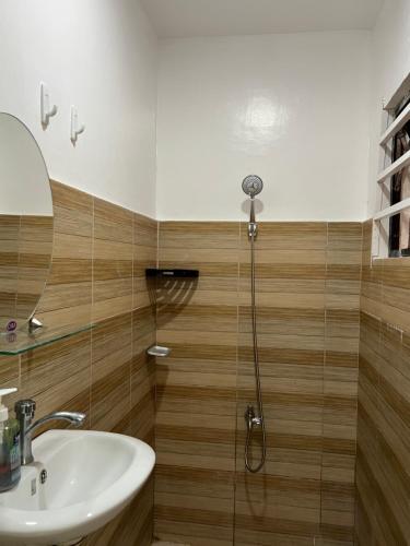 a bathroom with a sink and a shower at Reinhardshausen Suites and Residences- Lovely Air-Conditioned Units in Tuguegarao City