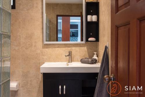 a bathroom with a sink and a mirror at Chaweng Hill 2Br in Koh Samui