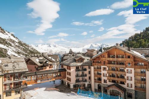 a view of a town with snow covered mountains at Résidence Pierre & Vacances Premium Arc 1950 Le Village in Arc 1950