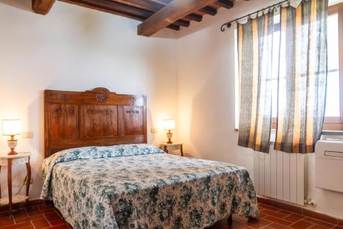 a bedroom with a bed and a large window at Il Cancellone - Riccio in Montiano