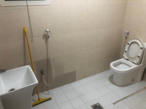 a bathroom with a toilet and a sink at Dubai NorthStar Hostels in Dubai