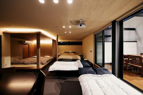 a bedroom with two beds and a large window at 634 Condo Shinjuku - Vacation STAY 01902v in Tokyo