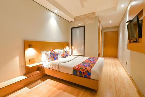 a hotel room with a bed and a tv at FabHotel Penthouse in Guwahati
