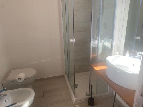a bathroom with a shower and a toilet and a sink at Villa Vinci in Recanati