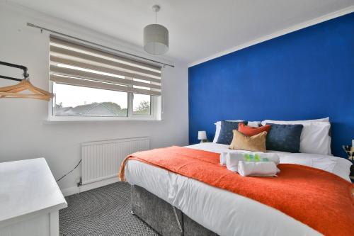 a blue and white bedroom with a large bed at StayRight 3BR House- Multiple Private Parking Spots - Modern Kitchen in Barry