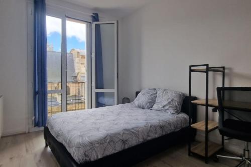 a bedroom with a bed and a large window at F4 - La Maison de M. Goéland in Le Havre