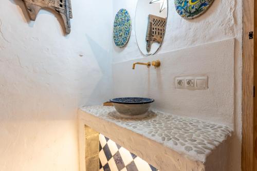 a small bathroom with a bowl on a table at 16 San Sebastian in Mijas