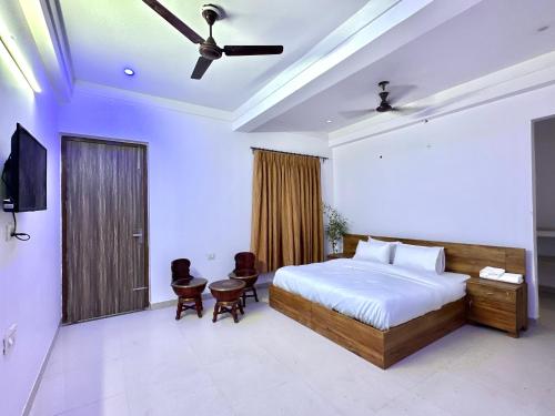 a bedroom with a bed and a ceiling fan at cozy room with no restrictions in Gurgaon