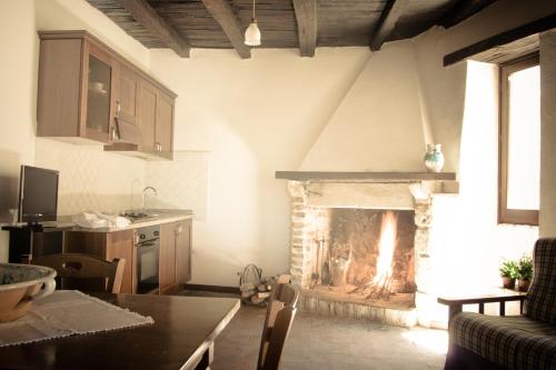 a kitchen and living room with a fireplace at Borgo San Valentino in Arrone