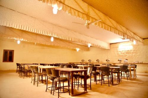 a large room with tables and chairs in it at Destination Desert Camp in Jaisalmer