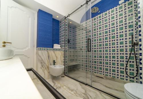 a bathroom with a glass shower and a toilet at Hotel Marincanto in Positano