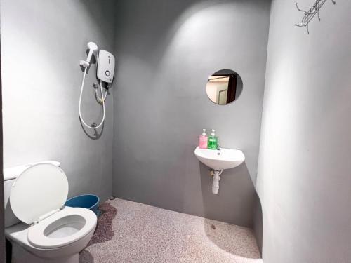 a bathroom with a toilet and a sink at HUKM CoLiving 21 by Manhattan Group in Kuala Lumpur