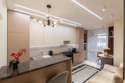a kitchen with a sink and a counter top at Royal 2 apartments on Shevchenka str in Lviv