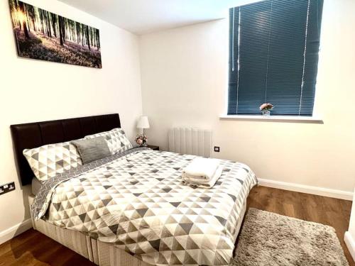 a bedroom with a bed and a window at Home from Homes in Bedford