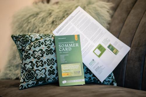 a box of sunscreen and a pillow on a couch at Smaragdhotel Tauernblick in Bramberg am Wildkogel