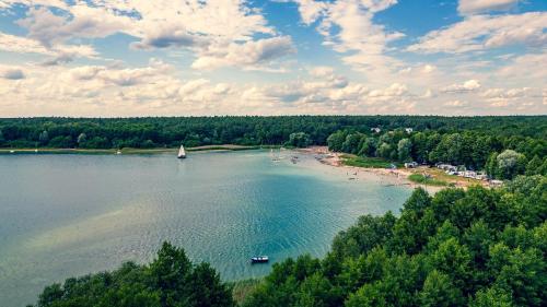 an aerial view of a lake with a beach and boats at Domek Na Winklu in Skrzynka