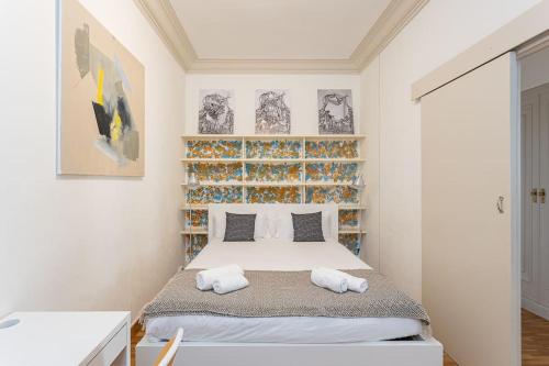 a bedroom with a bed with two towels on it at Canela Homes BARCELONA MODERNISTA in Barcelona