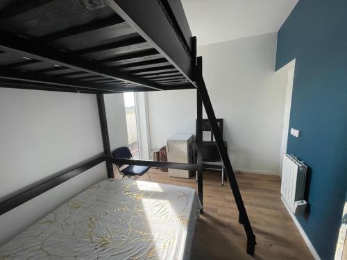 a bedroom with a bunk bed and a desk at Rooftop vue sur le Stade de France in Saint-Denis