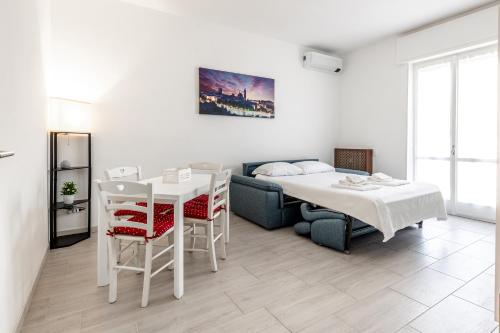 a living room with a bed and a table and a bed at [House Near Train Station]A/C in Seriate
