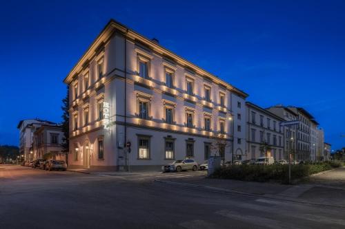 un edificio bianco con luci sul lato di Hotel Ariele a Firenze