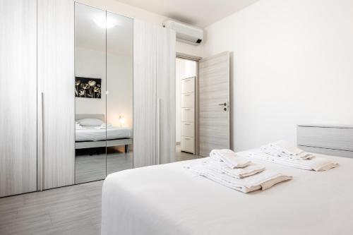 um quarto branco com uma cama e um espelho em [House Near Train Station]A/C em Seriate