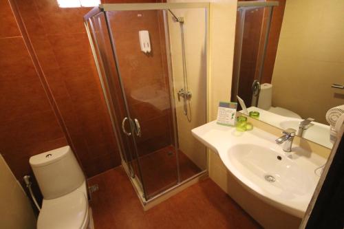 a bathroom with a shower and a toilet and a sink at KRABI CHARM in Ban Khlong Haeng