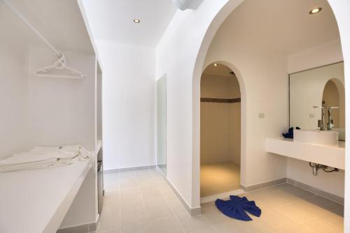 a bathroom with a sink and a mirror at La Perle Resort Koh Samui in Mae Nam