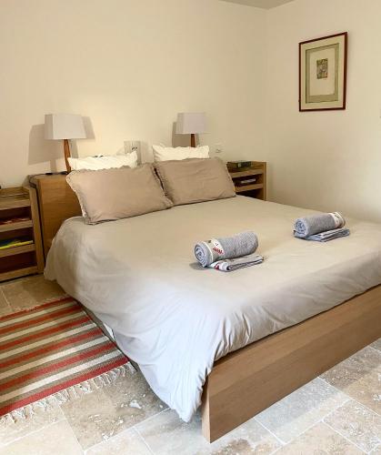 une chambre avec un grand lit avec deux oreillers dessus dans l'établissement La Grange Symphorine, chambre d'hôtes de charme située entre la vallée de la Dordogne et la vallée de la Vézère, à Meyrals