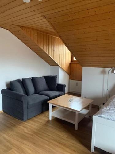 a living room with a blue couch and a coffee table at Apartment 62 in Zwiesel