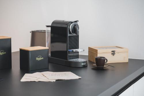 a desk with a coffee maker and boxes on it at NEU: Stylische Suite mit Netflix und Workspace in Böblingen