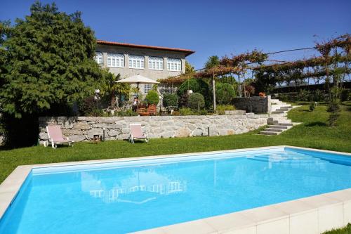 a swimming pool in the yard of a house at Casa da Costeira in Guimarães