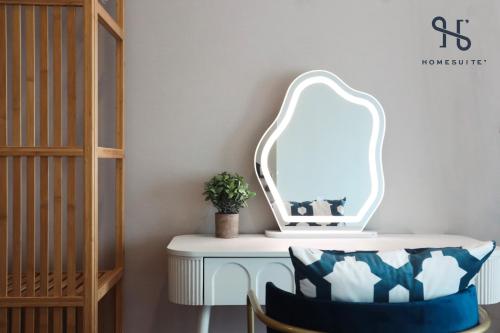 a dressing table with a mirror and a chair at Homesuite' Home at The Loft in Kota Kinabalu