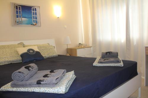 a bedroom with a bed with towels on it at Lovely 1-bedroom apartment with pool, 250 m to the beach in Pomorie