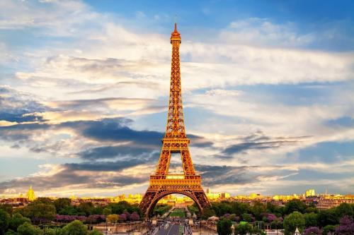 a view of the eiffel tower at sunset at Kimpton - St Honoré Paris by IHG in Paris