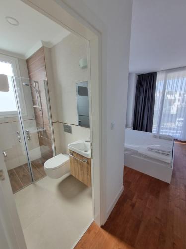 a bathroom with a toilet and a sink and a shower at Four Seasons Life Rentals in Trikomo