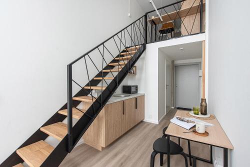 a loft conversion with a staircase and a desk at We LOFT in Vilnius