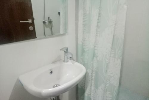 a bathroom with a sink and a mirror at RedLiving Apartemen Royal Sentul Park - Budi Property in Cikeas