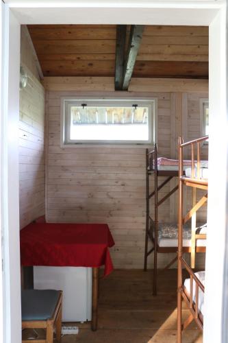 a small room with a bed and a window at Camp Telč - U Roštěnky in Telč